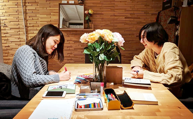 手紙を書く2人の女性